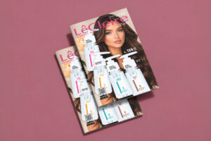 Portada del catálogo Cosmetics de LêCleire, campaña de octubre 2026 para Honduras, con modelo y frascos de gotas para peinar